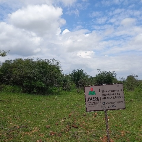 Amara Lands board staked on an open client plot under an open sky in the HMDA belt